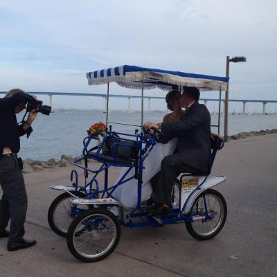 a group of people riding on the back of a bicycle