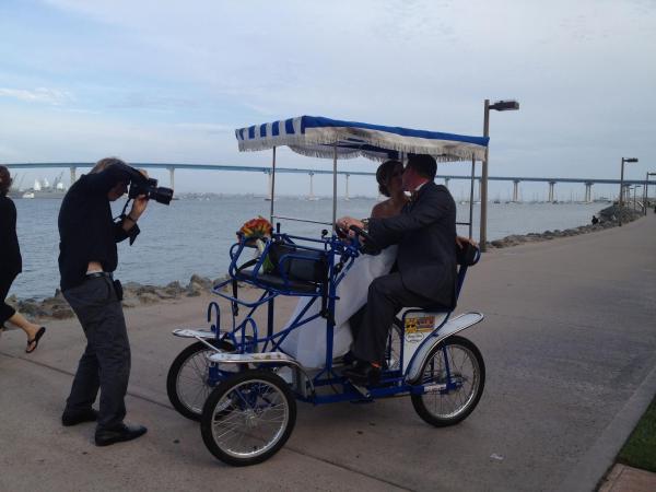 a group of people riding on the back of a bicycle