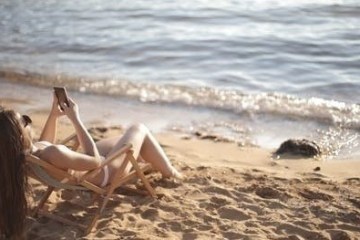 a person lying on a sandy beach