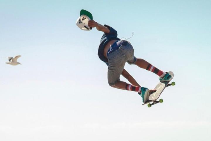 a man flying through the air while riding a skateboard