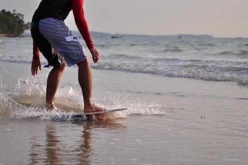 a man riding a wave on a surfboard in the water