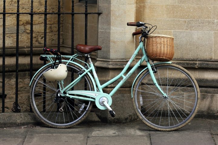 a bicycle parked in front of a brick building