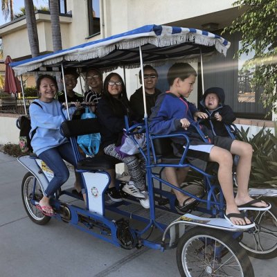a couple of people that are sitting on a bicycle